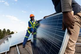 African man installing solar panel